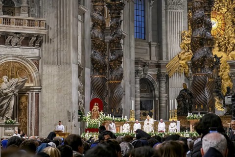 View of heads of faithful in the foreground at the bottom of the picture Pope Saint Father with