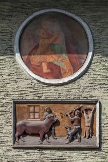 Relief depiction of a house slaughter above a saint at a town house, Going am Wilden Kaiser, Tyrol,