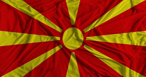 Macedonian flag with fabric texture background. National flag of North Macedonia with cloth texture