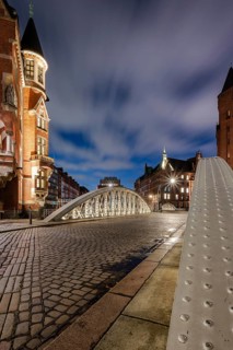 Blue hour in the Speicherstadt Hamburg on the Neuerwegsbrücke with cobblestones in the foreground