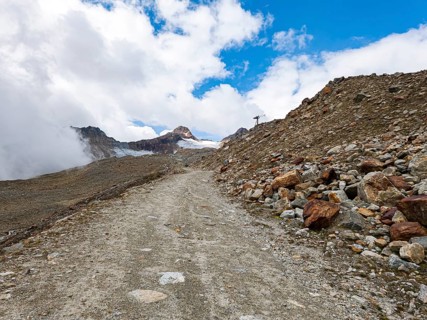 Mountain hiking trail in alpine mountain scenery in the area of the Tiefenbach Glacier near Sölden,