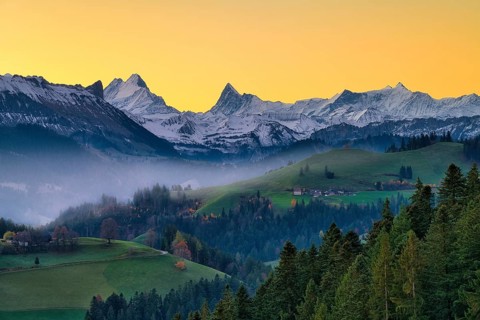 View of snow-covered Bernese Alps with Schreckhorn and Finsteraarhorn at dawn, Langnau im Emmental,