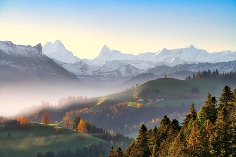 View of snow-covered Bernese Alps with Schreckhorn and Finsteraarhorn at sunrise, Langnau im