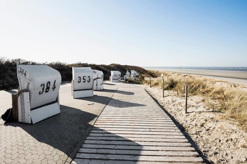 Beach chairs in the dunes and blue sky in winter, Spiekeroog, East Frisian Islands, Lower Saxony,