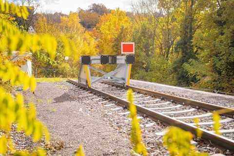 Railway track ends with a barrier surrounded by autumnal nature, ZOB Calw, Hermann Hessebahn, Calw,