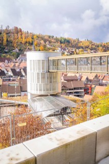 Autumn cityscape with a modern building and hill in the background, ZOB Calw, Hermann Hessebahn,