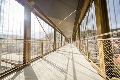 Long, modern footbridge with shadows cast by metal grids, ZOB Calw, Hermann Hessebahn, Calw,