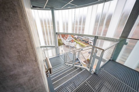 Staircase inside a building with a view of the city and roof landscape, ZOB Calw, Hermann