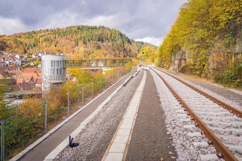 Railway tracks in autumn landscape with views of wooded hills and a city, ZOB Calw, Hermann