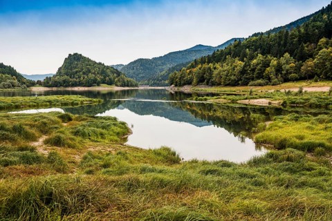 Picturesque mountain lake with water reflections in autumn, Lac de Kruth-Wildenstein, Kruth,