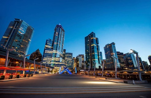 Illuminated skyscrapers on the promenade in the evening, Olympic Cauldron Statue, Jack Poole Plaza