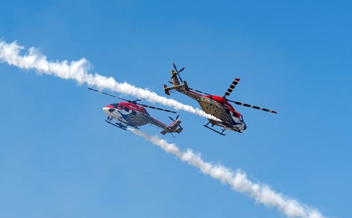 Indian Air Force (IAF) ALH Mk1 Sarang helicopters soar through the sky during an air show as part