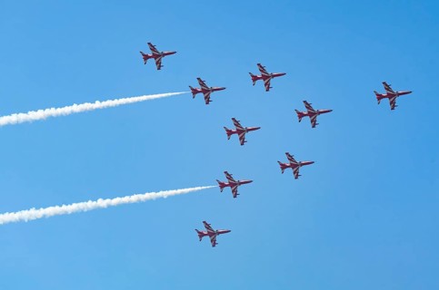 The Indian Air Force (IAF) Surya Kiran aerobatics team performs during an air show as part of the