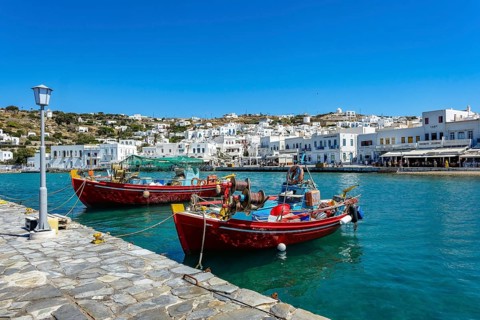 Mykonos, Cyclades, Greece - Colourful fishing boats are moored on the quay in the old port of