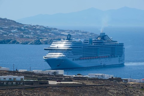 Mykonos, Cyclades, Greece - cruise ship MSC Divina sails to Mykonos harbour bay