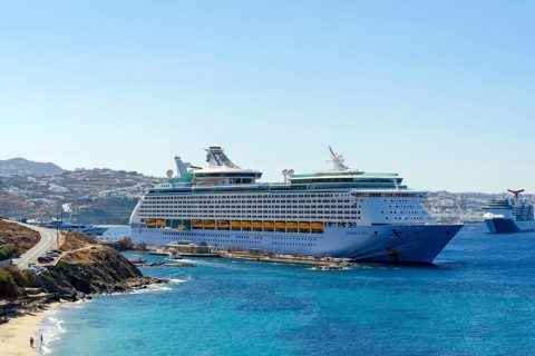 Mykonos, Cyclades, Greece - Voyager of the Seas cruise ship is located in Mykonos Harbour Bay. In