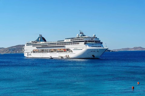 Mykonos, Cyclades, Greece - Cruise ship MSC Lirica is located in Mykonos Harbour Bay. Cruise ships