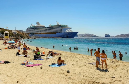 Mykonos, Cyclades, Greece - Voyager of the Seas cruise ship is located in Mykonos Harbour Bay. In