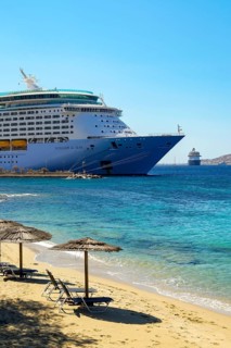 Mykonos, Cyclades, Greece - Voyager of the Seas cruise ship is located in Mykonos Harbour Bay.