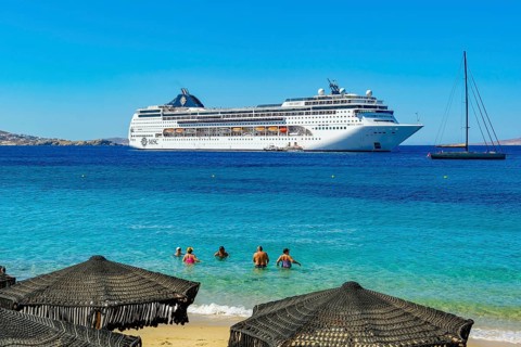 Mykonos, Cyclades, Greece - Cruise ship MSC Lirica is located in Mykonos Harbour Bay. Cruise ships