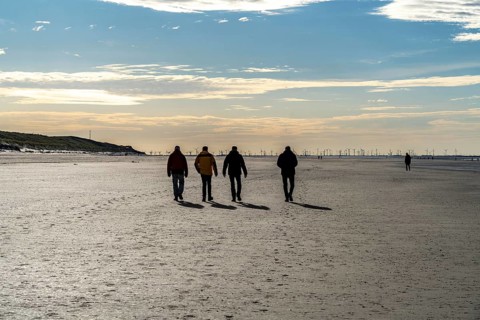 Walkers on the Wadden Sea near the East Frisian island of Spiekeroog, west of the North Sea island,