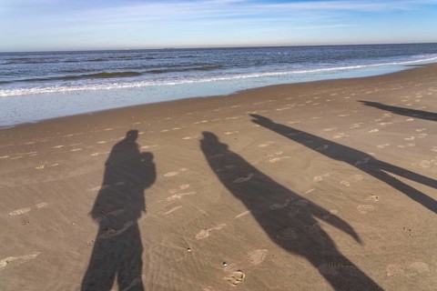 East beach of the East Frisian island of Spiekeroog, shade of walkers on the beach, Lower Saxony,