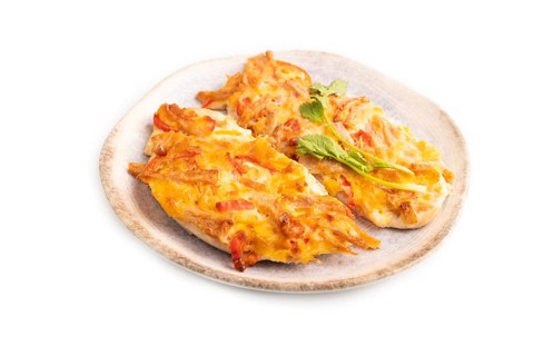 Baked chicken meat with cheese and tomatoes isolated on white background. side view, close up