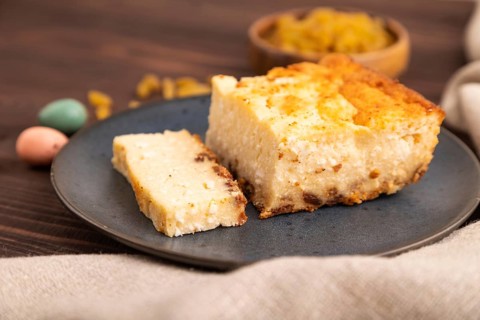 ?ottage cheese ?asserole, Curd cake, with dried apricots and raisins on brown wooden background and