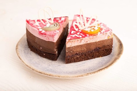 Chocolate cake on white wooden background, side view, close up
