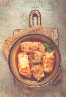 Stuffed cabbage rolls with minced meat, in tomato sauce, top view, without people, in the spotlight