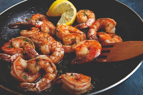 Fried tiger prawns, jumbo, in garlic sauce, in butter, with herbs, in a frying pan, homemade, no