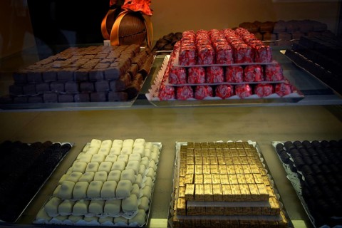 Showcase full of finely arranged Belgian chocolates in various types and colors, appetizingly