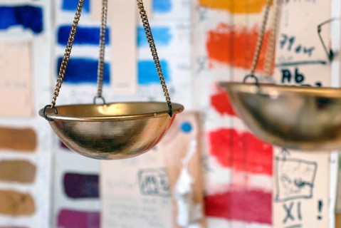 Libra hangs in front of colorful color sample cards in an artist studio, Zurich, Switzerland
