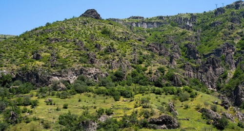Green hills and rocky landscape under a clear summer sky, landscape near Goris, Hoodoos, Syunik