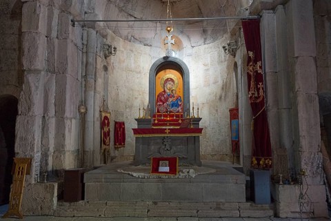 Church altar with icon of the Holy Mother surrounded by candles and religious symbols, Vahanavank