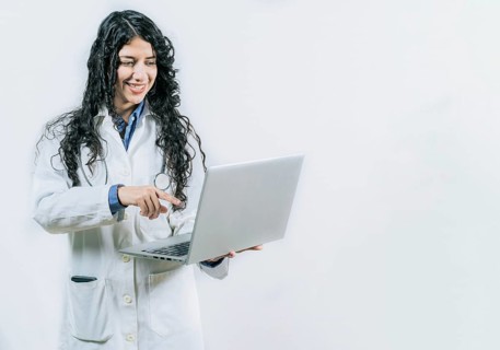 Female young doctor using and pointing laptop isolated. Smiling Woman doctor using laptop on