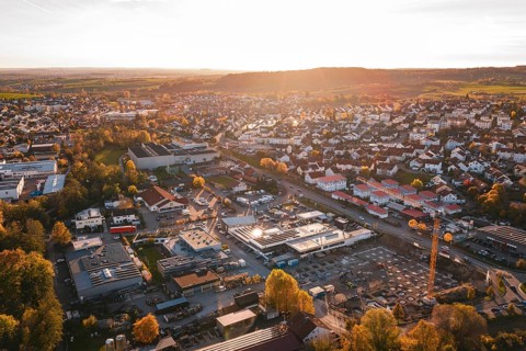 Small town with industrial facilities in warm evening autumn light, Grossbottwar, Germany