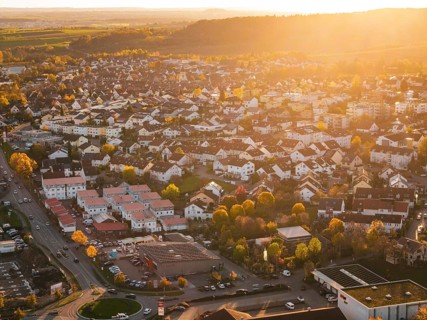 Closely standing houses in a city at autumn sunset, roads visible, Grossbottwar, Germany