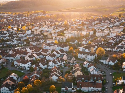 Dense residential area with autumn colors and festive sunset light, Großbottwar, Germany