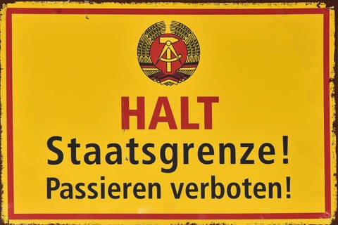 Old sign on the border of West Berlin and East Berlin, during the Cold War, Berlin, Germany