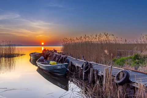 Fishing boats at wooden jetty on Lieper Winkel peninsula near Rankwitz on Usedom island in the