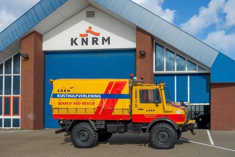 KNRM Mercedes-Benz Unimog 435 truck in front of sea search and rescue lifeboat station at