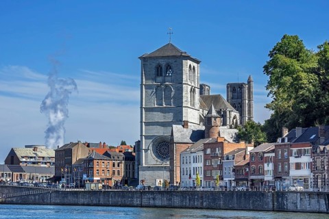 16th century Gothic Notre-Dame collegiate church along the Meuse river in the city Huy, province of