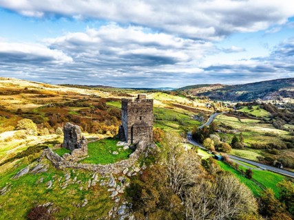 Autumn colours over Castell Dolwyddelan and Eryri Mountains from a drone, Snowdonia, Conwy County