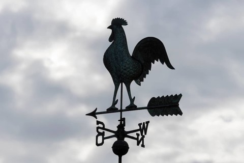 Weathercock silhouette against cloudy sky, looks mystical and dark, Baden-Württemberg, Germany