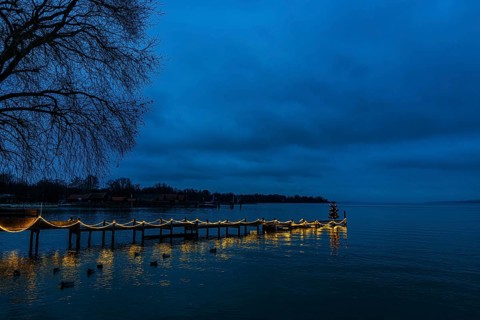 Illuminated Christmas tree at dawn, on an illuminated boat dock, Dießen am Lake Ammer, Upper