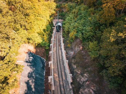 Rail construction site in the forest taken from the air with tunnel boring machine, construction of