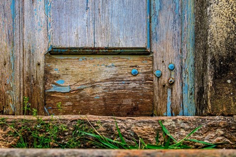 Details of an old baroque church door made of wood, weathered by time, in Ouro Preto city, Ouro