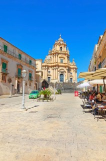 Tourists sitting in local restaurants in the main square, Ragusa Ibla, Ragusa province, Sicily,