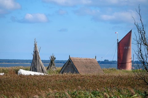 Zeesboot at a dock in the lagoon, fishing hut in the reed in front, Ahrenshoop, Darß,